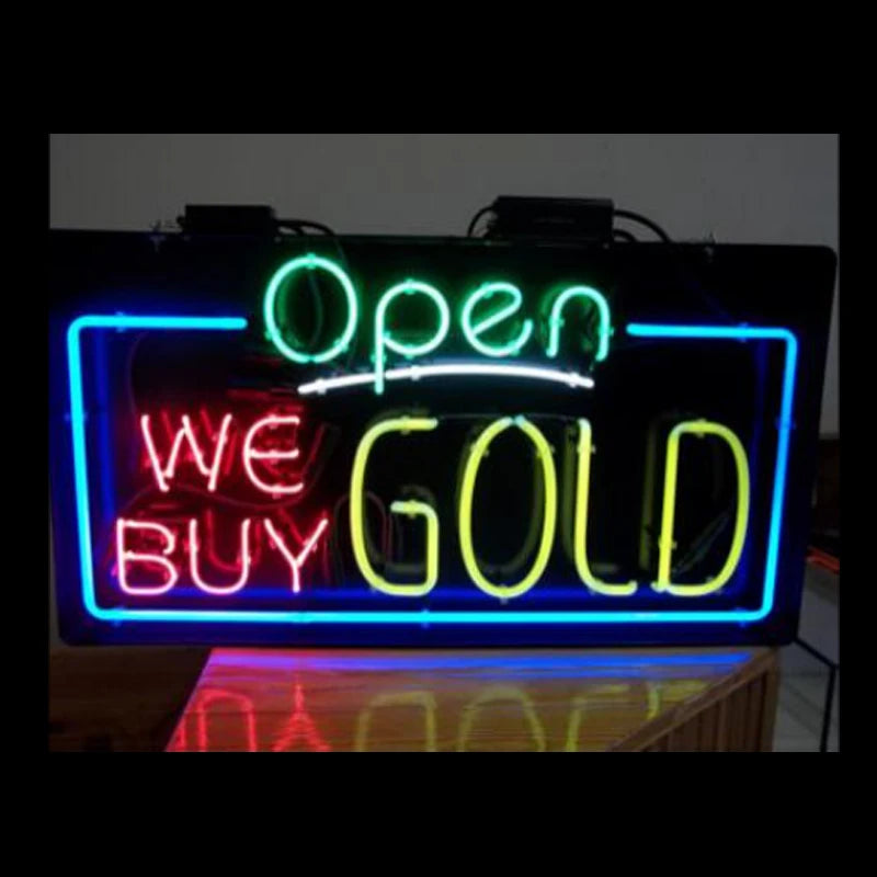 Neon sign on a brick wall that reads 'Open We Buy Gold'.
